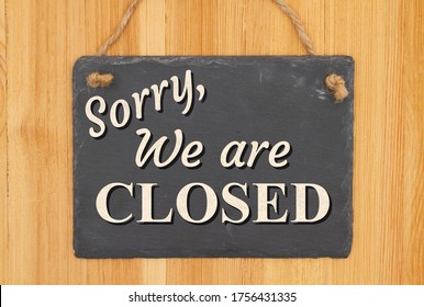 Sorry We Are Closed Type Message On A Hanging Chalkboard Sign On Wood