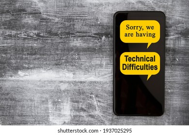 Sorry We Are Having Technical Difficulties Message On A Black Mobile Phone