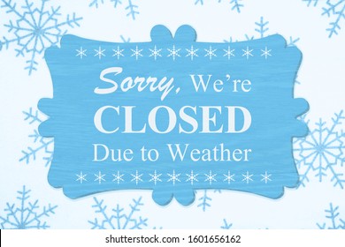 Sorry We're Closed Due to Weather message on a wood sign with a blue snowflakes - Shutterstock ID 1601656162