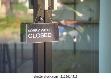 "sorry we're closed" label in front of glass door at the coffee shop to notice customer service                                                             - Shutterstock ID 2113614518