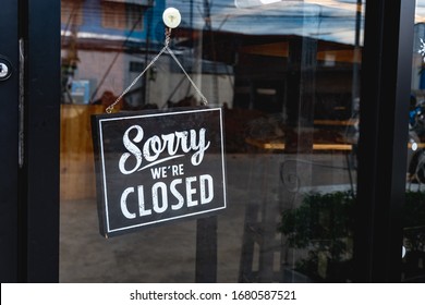 "Sorry we're closed" message board on a window - Shutterstock ID 1680587521