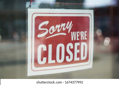 Sorry we're closed sign behind dirty glass door during corona lockdown - Powered by Shutterstock