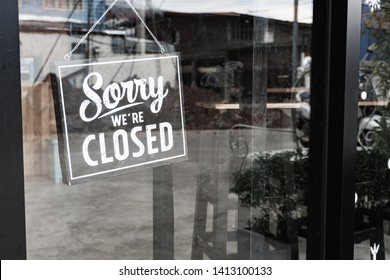 Sorry we're closed sign. grunge image hanging on a dirty glass door. - Shutterstock ID 1413100133
