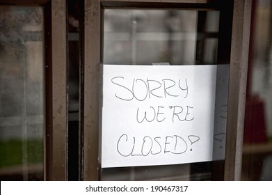 A Sorry We're Closed Sign Hanging At A Food Stop That Was Flooded.