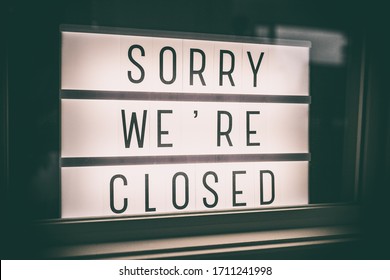 SORRY WE'RE CLOSED Storefront Window Sign. Coronavirus Closure Due To COVID-19 Message Board In Business Retail Store Lightbox At Night. Shutdown Of Restaurants, Stores, Non Essential Services.