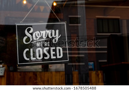 Sorry we're closed . vintage black and white retro sign on a coffee glass door