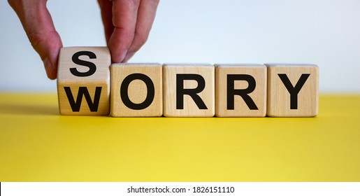 Sorry to worry. Hand turns a cube and changes the word 'worry' to 'sorry'. Beautiful yellow table, white background. Business concept, copy space. - Shutterstock ID 1826151110