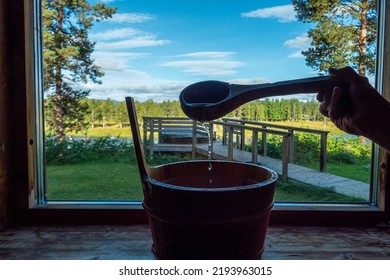 Sorsele,Sweden A water bucket and laddle in a sauna with a window over Swedish Lappland.