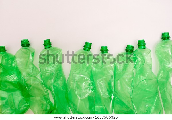 Sorted plastic green bottle
for recycling and waste sorting and white background with copy
space for your text. Eco-friendly habits for modern lifestyle
concept  
