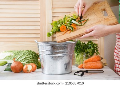 Sorting of household waste, composting. Collecting of food waste in trash-can for recycling. Woman throws vegetable peeling, scraps in compost bucket. Food waste reduce. Zero waste lifestyle.  - Shutterstock ID 2105857010