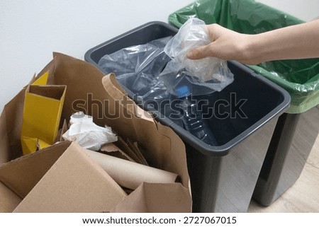 Sorting household waste into separate containers for recycling. Eco friendly lifestyle, waste separation, sustainable living concept and environmental responsibility.