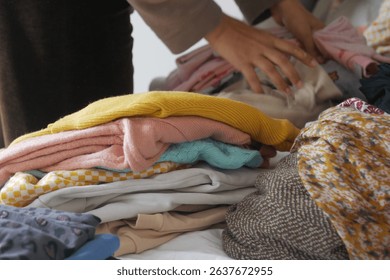Sorting and organizing clothes on a table