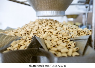 sorting and packing line of stuffed breakfast cereal pillows at factory conveyor for cereal snack production of flour products, technology production in food Industry
