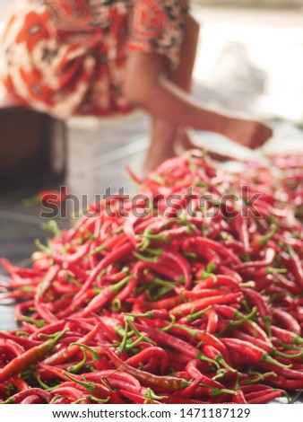 Sorting red chillies for sale at Pare market