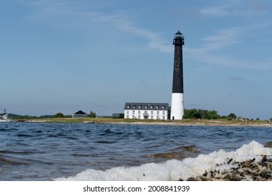 Sorvesaar,Estonia-06.21.2021: Lighthouse At The End Of Sorve Saar Peninsula. Tall Beacon Of Light For The Ship To Guide Them Throw Shallow Waters. Historical Light House At Its Full Restored Glory