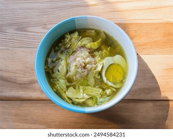 Soto ayam or chicken soto is traditional Indonesian soup mainly composed of clear herbal broth by tumeric, chicken and vegetables. Served with boiled egg, lime and fried shallots. - Powered by Shutterstock