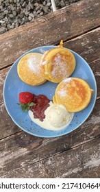 souffle pancake with blueberries, strawberries, honey and vanilla ice-cream - Shutterstock ID 2174104649