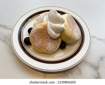 Souffle Pancakes With Cream In Plate.