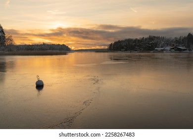 Soukka, Finland - 09.12.22: Winter sunset over the snow-covered islands in the bay. Frozen bay. Winter landscape. Scandinavia. - Powered by Shutterstock