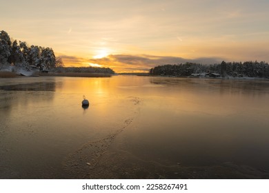 Soukka, Finland - 09.12.22: Winter sunset over the snow-covered islands in the bay. Frozen bay. Winter landscape. Scandinavia. - Powered by Shutterstock