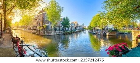 Soul of Amsterdam. Early morning in Amsterdam. Ancient houses, bridges, traditional bicycles, canals, boats. Panoramic view with all the sights of Amsterdam. Holland, Netherlands, Europe.