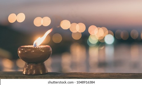 Soul and spirituality abstract concept  for mourning and world human spirit day with warm candle light bokeh illumination, golden sunset sky and reflective river wave background - Shutterstock ID 1048916384