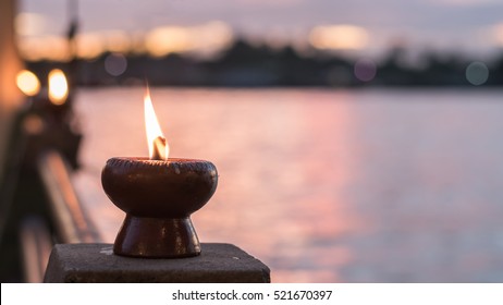 Soul and spirituality abstract concept  for mourning and world human spirit day with warm candle light bokeh illumination, golden sunset sky and reflective river wave background