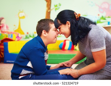 soulful moment. portrait of mother and her beloved son with disability in rehabilitation center - Shutterstock ID 521324719