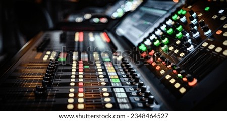 Sound and audio adjusting control panel with buttons, sliders and display. Digital music record mixer equipment for dj and musician media production