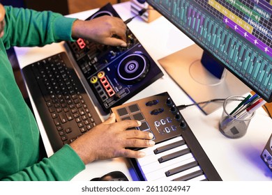 Sound engineer artist adding effects on his audio files in post production, working with a console and daw software to mix and master tunes. Musician adjusting songs volume levels. Close up.