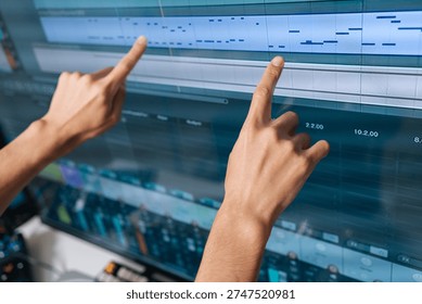 Sound engineer hands interacting with digital audio workstation software, creating and editing music production with modern midi notes on computer screen, close-up.