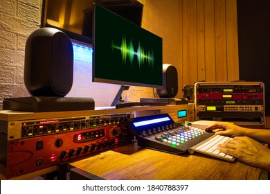 sound engineer hands working on digital professional audio equipment in recording, editing, broadcasting studio