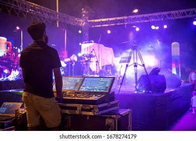 Sound engineer team working to prepare for music concert stage. Hand adjusting audio mixer. DJ for work at a concert in front of the stages