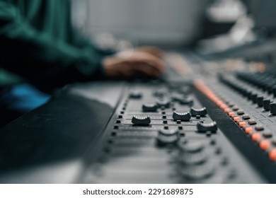 Sound engineer used digital audio mixer Sliders Engineer presses key Control panel Recording studio technician