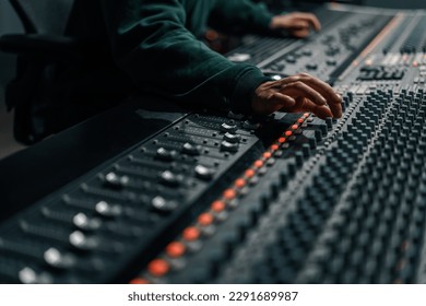 Sound engineer used digital audio mixer Sliders Engineer presses key Control panel Recording studio technician