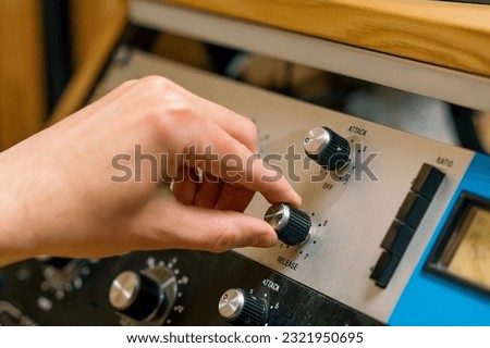 Sound engineer using digital audio mixer sliders Engineer pressing keys add control panel volume Recording studio technician close up