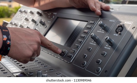 sound engineer at work with mixing console