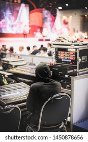 Sound engineer working at audio control panel in seminar room ,microphone meeting room Selective Focus.
