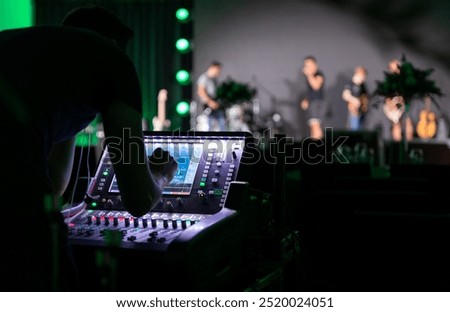 Sound engineer working backstage while preparing audio equipment for a live concert