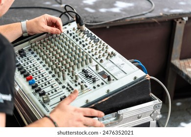 Sound engineer working with a professional sound console - Powered by Shutterstock