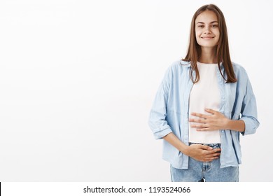 Sound mind in healthy body. Portrait of delighted joyful young european female taking care of health touching belly or stomach with pleased happy smile taking vitamins or drinking yoghurt - Shutterstock ID 1193524066