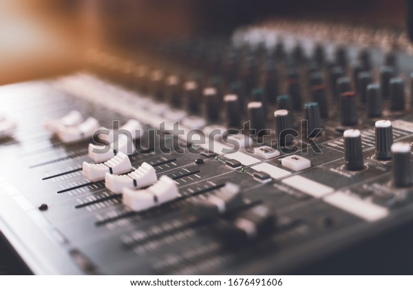 Sound mixer. Professional audio\
mixing console with lights, buttons, faders and\
sliders.