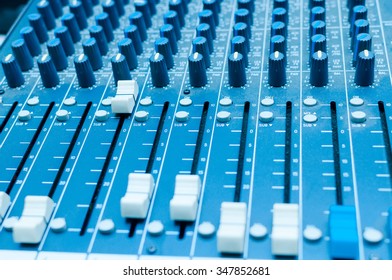 Sound mixer in studia in blue light. Control panel music.