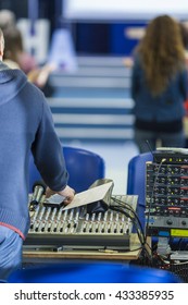 Sound Operator at Work in front of Sound Mixing Console. Vertical Image Composition
