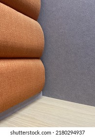 A Sound Proof Room With Orange And Grey Wall And Wooden Table