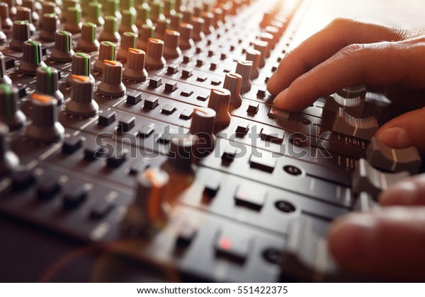 Sound recording studio mixing desk with engineer\
or music producer