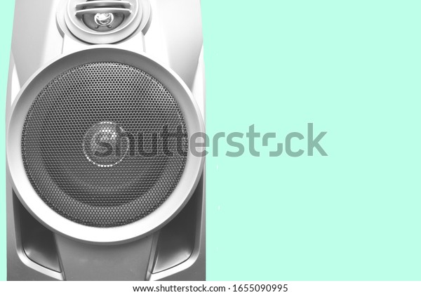 Sound speaker with copy space  on a green\
isolated background.