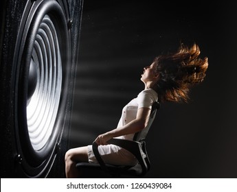 The sound wave set back an office chair with young woman. - Shutterstock ID 1260439084