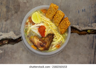 A soup called Soto Berau is a typical food from Berau, East Kalimantan. contains ricecake, vermicelli, sweet potato chips, omelette, fried tempe, fried chicken, sambal with soup full of spices