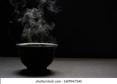 Soup Hot In Black Bowl On Wooden Table,food Steam And Copy Space ,selective Focus.Fresh Foods Concept
